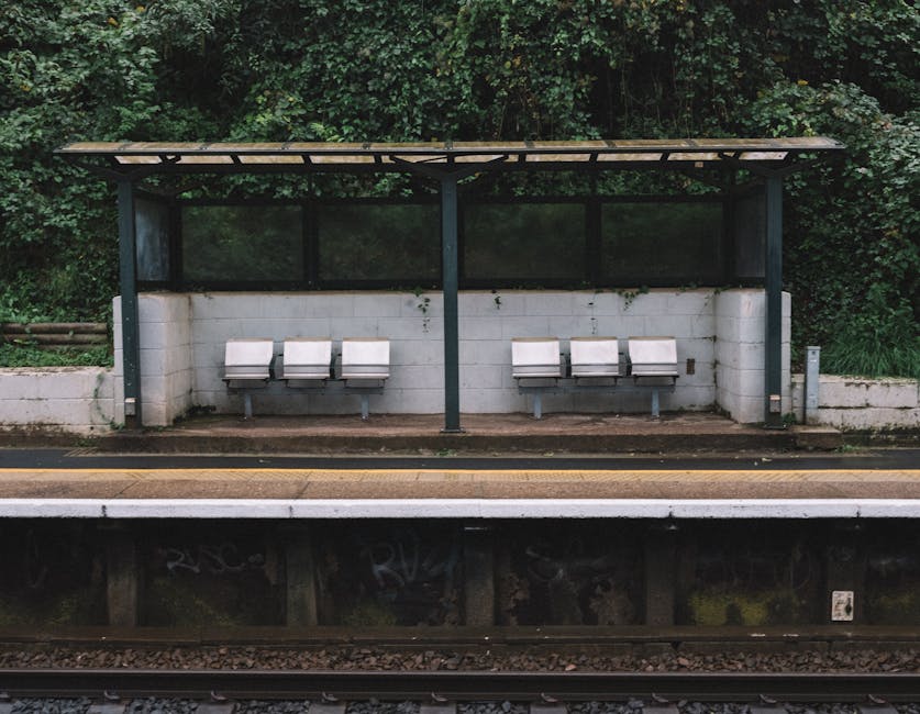 Photograph taken at Honor Oak Park Station showcasing a modern train arriving or departing along the railway tracks. The station platform is visible with a few passengers waiting, and the station’s